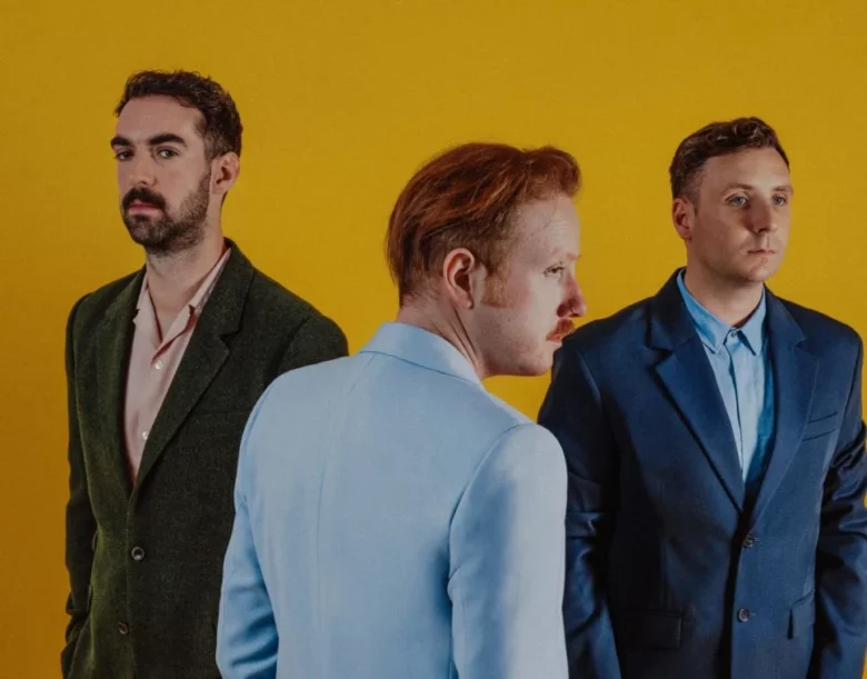 two door cinema club in front of a yellow background